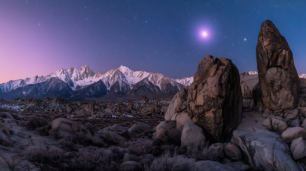 Majestic Night Sky over Snow-Capped Mountains and Granite Boulders. photo