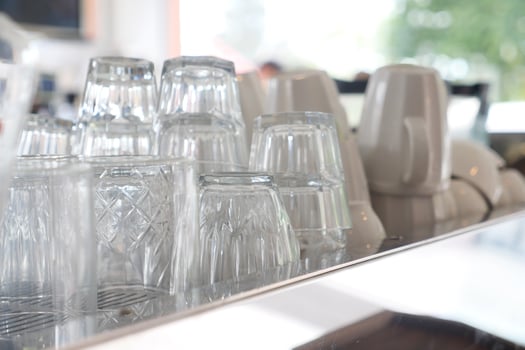 Glasses stacked on counter ready for service at cafe photo
