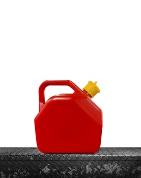 Red plastic oil can on a metal background. photo