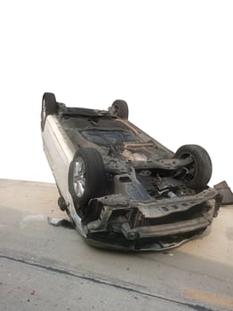 Cars damaged after crashing and overturning on the road during daytime. Car accident. photo