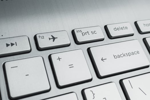 Closeup of Laptop Keyboard with Delete, Backspace, and Airplane Mode Keys photo