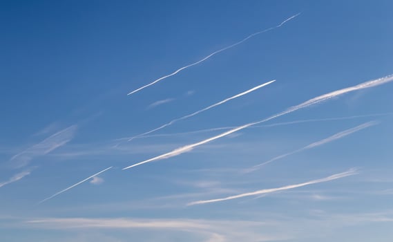 Contrails - a flying transport airplanes with condensation trails in the a sky photo