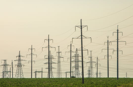 High-voltage power line in the field. Electricity pylons in the evening. Electric tower. Power transmission lines. energy security and clean energy. photo