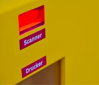 Red laser scanner and printers for shipping labels are installed at a DHL Packstation photo