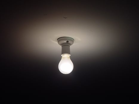 a light bulb is lit up in the dark photo