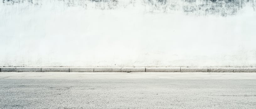 Urban blank wall with clean pavement at midday photo