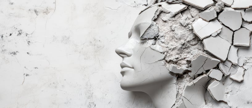 Sculpture of a head breaking through the wall photo
