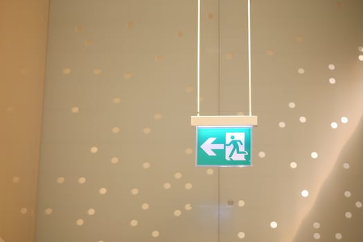 Exit sign directs to safety in bright space photo