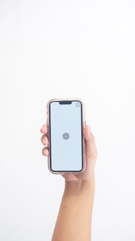 Yogyakarta, Indonesia, 2025 - Hand holdingHand holding smartphone that shows front page of ChatGPT application, an artificial intelligence platform, on screen isolated on white background photo