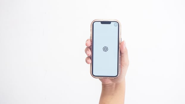 Yogyakarta, Indonesia, 2025 - Hand holdingHand holding smartphone that shows opening page of ChatGPT application, an artificial intelligence platform, on screen isolated on white background photo