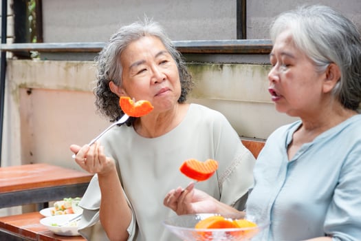 Happy Retirement Lifestyle, Senior Asian Friends Sharing Food and Conversation, Women Enjoying Fruits Together Outdoors photo