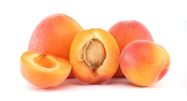 Fresh Vibrant Apricots Perfectly Displayed with Sliced and Whole Fruits photo