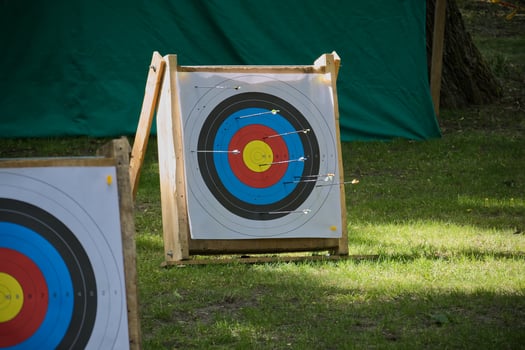 Wooden Archery Target with Bullseye in Outdoor Training Range photo
