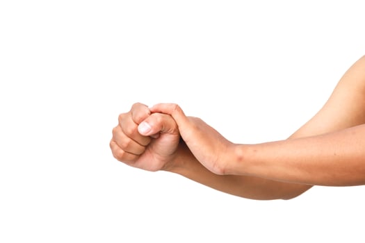Hand massaging another hand in a gesture of pain relief or support on white photo