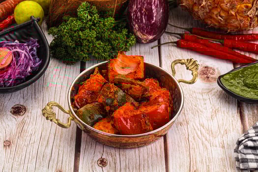 A table with a bunch of different vegetables and a bowl of food photo