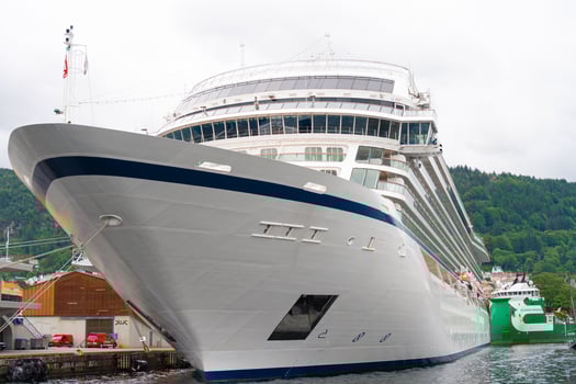 Bergen, Norway - July 11, 2024. Front view of large cruise ship docked in fjord harbor photo