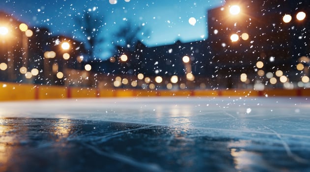 Snowy ice rink scene at night with blurry buildings and street lights backdrop photo