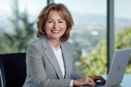 Smiling businesswoman working on laptop in office with scenic view photo