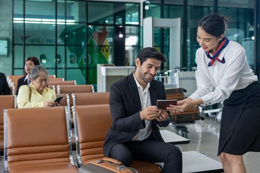 Businessman passenger is showing boarding pass to airline ground crew at departure gate into the airplane for final inspection before boarding to plane photo