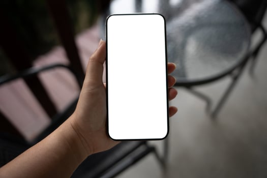 a person holding blank white smartphone screen. photo