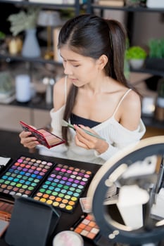 a woman is looking at her makeup products photo