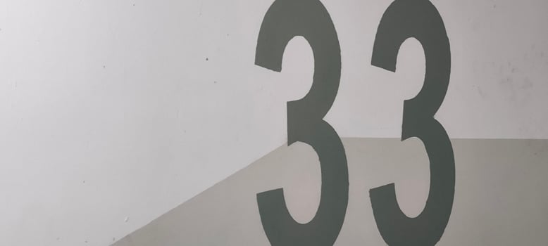 Graphic Composition of Number Thirty-Three on Textured White and Gray Surface photo