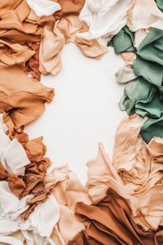 Assorted Fabric Scraps Forming Border, Earth Tones, White Background. Concept Zero Waste Living. photo