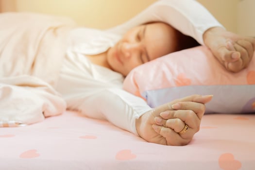 Sleepy female keeping eyes closed while dreaming about future vacation or sleeping at the bedroom. photo