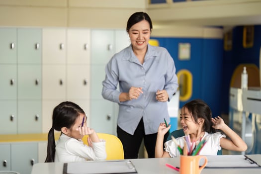 Back to School. Teacher celebrating learning with students in a vibrant classroom. photo