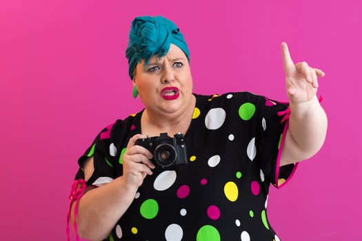 Plus size woman giving instructions with camera photo