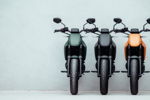 Sleek and Stylish Motorcycles Parked Against a Grey Wall A Trio of Modern Bikes Showcases Urban Transportation Design photo
