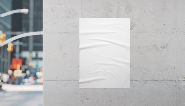 White poster on urban building wall with street view around the corner, perfect for advertisement, design promotion, and creative poster mockup photo