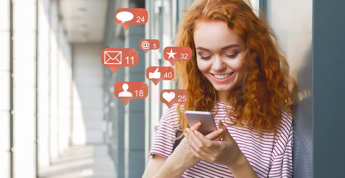 Blogger using phone with social media notification icons, panorama photo