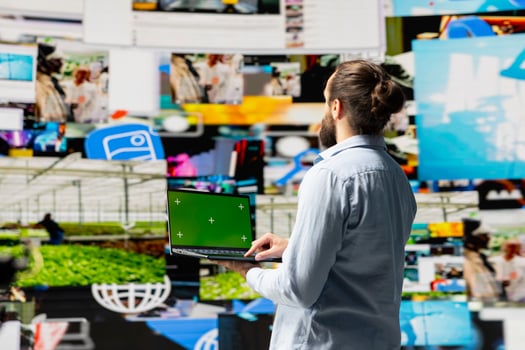 Social media manager uses device with isolated display for online presence, using his imagination and storytelling skills to connect with followers and boost online engagement. Modern web design. photo