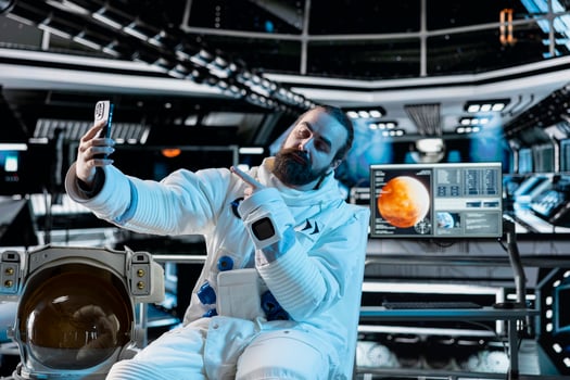 Cosmonaut doing selfies with smartphone during Mars expedition for future of mankind. Astronaut taking pictures using phone in spaceship, exploring red planet to support human life beyond Earth photo