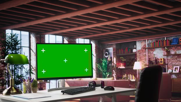 Luxurious apartment workspace with chroma key screen on clean empty desk. Spacious interior features wood and glass elements, creating refined and cozy ambiance with artistic flair. photo