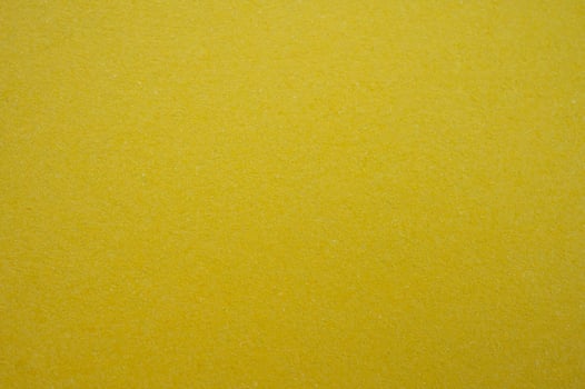 Full frame shot of recycled yellow paper sheet texture and background. Colored paper or construction paper, is a type of paper that comes in a wide range of colors. photo