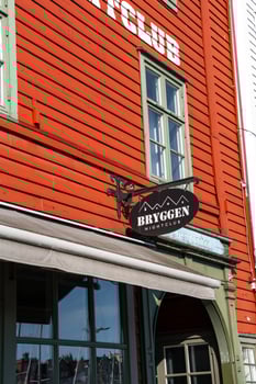 Bergen, Norway - July 9, 2024. Sign of Bryggen Nightclub on traditional wooden facade photo