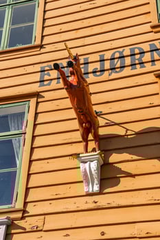 Bergen, Norway - July 9, 2024. Unicorn sculpture on historic facade of Enhjorningen restaurant photo