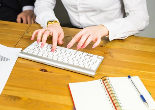 Female office worker typing on the keyboard photo