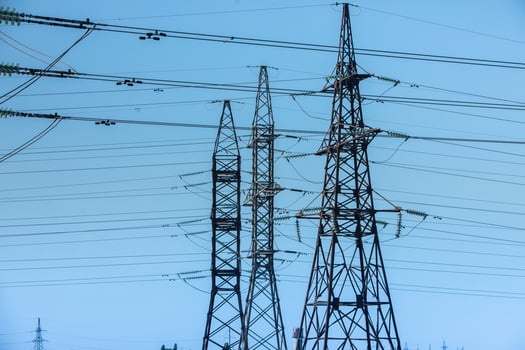High voltage power lines and pylons against blue sky. Electric tower. Power transmission lines. Energy security and clean energy. photo