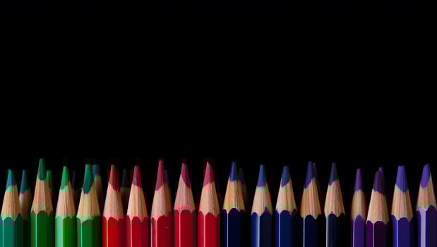 Bottom-Aligned Jewel Toned Pencil Stack with Black Background photo
