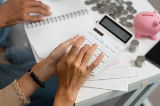 Couple Calculating Finances Together. Engaging in budgeting with a calculator and piggy bank. photo