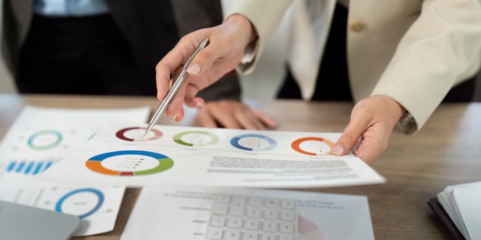 Business Collaboration and Financial Analysis. Professionals reviewing data reports together. photo