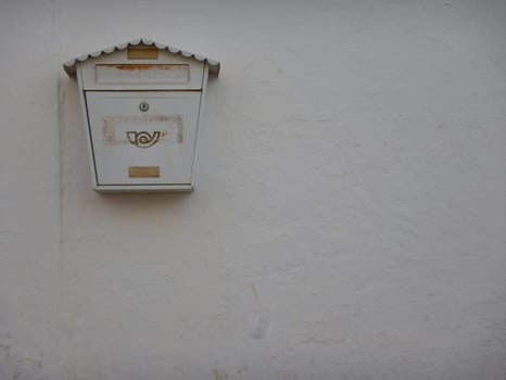 White mailbox hanging on a white wall photo