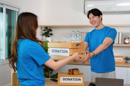 Donation Activity. Volunteers engaging in charitable giving with donation boxes. photo