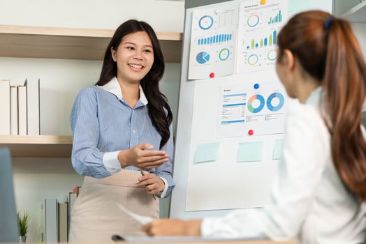 Engaging Business Presentation. Female professional explaining data insights to colleague in office. photo