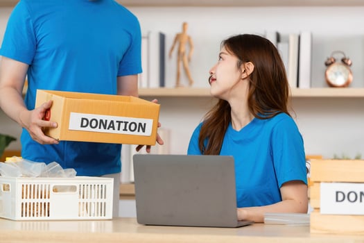 Donation in Action. A woman engaging in community support while receiving donations. photo