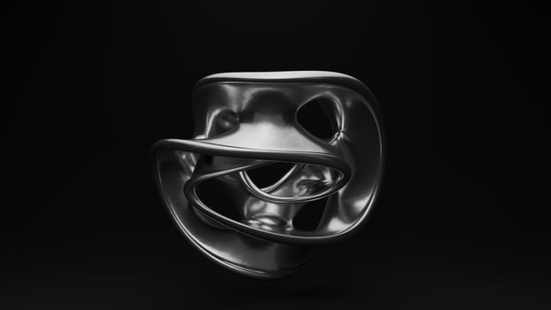 A black and white photo of a metal mask