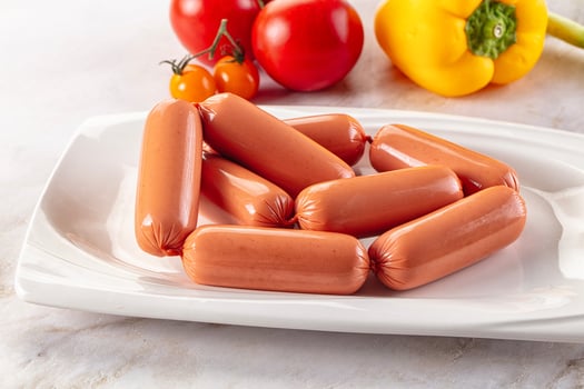 A white plate with hot dogs photo
